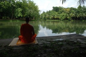 Sitting on dam meditating with open awareness