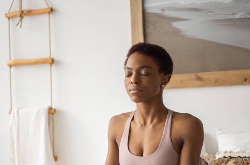 Woman meditating with eyes closed